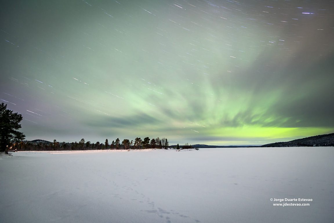 Aurora Borealis in Inari, Lapland, Finland. The phenomenon known as Northern Lights is caused when the particles released from the sun reach the earth's atmosphere